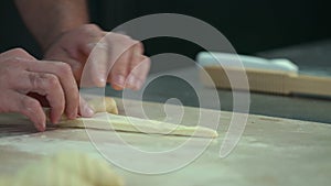 Male baker preparing croissants at his kitchen