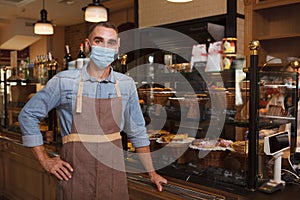 Male baker wearing face mask at his store