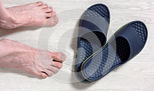 Male Bare Feet and a Pair of Flip Flops