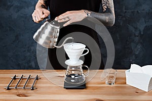 Male barista brewing coffee. Alternative method pour over.