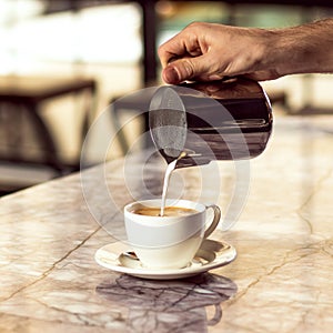 Male barista making coffee. Making latte art