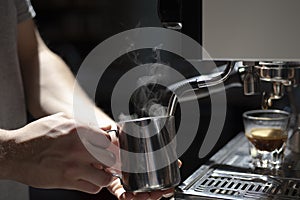 Male barista making espresso at a coffee shop