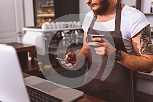 Male bartender having coffee break