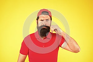 Male beauty tips. serious mature hipster yellow background. bearded man red shirt and cap. Hipster lifestyle. Barber