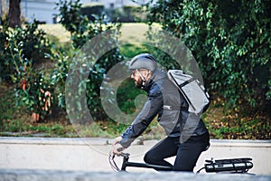 Male bicycle courier delivering packages in city. Copy space.