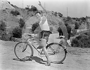 Male bicyclist waving photo