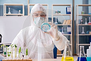 The male biotechnology scientist chemist working in the lab