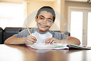 A male black child doing homework at home