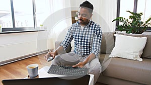 Male blogger with keyboard videoblogging at home