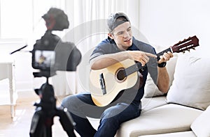 Male blogger recording music related broadcast at home
