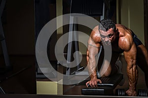 Male bodybuilder doing heavy weight exercise for back