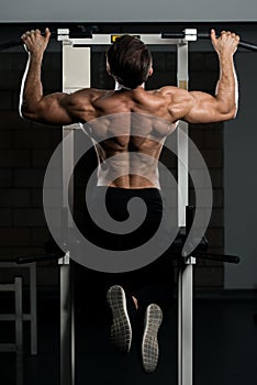 Male Bodybuilding Athlete Doing Pull Ups