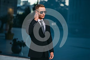 Male bodyguard uses security earpiece outdoors