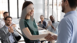 Male boss handshake female employee greeting with success at meeting