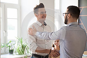 Male boss handshaking intern greeting with job promotion