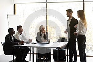 Male boss introduce female newcomer at meeting