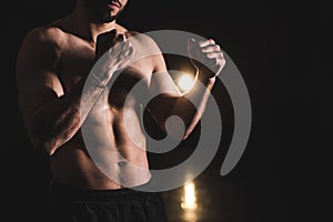 Male boxer doing shadow boxing inside a boxing ring. Boxer practicing her punches at a boxing studio. Black background