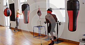 Male boxer practicing boxing in fitness studio 4k