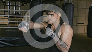 Male boxer shadowboxing in gym