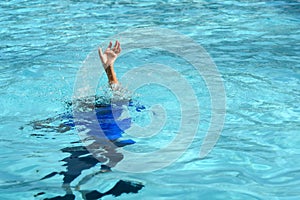 Male boy struggling underwater drowning in swimming pool