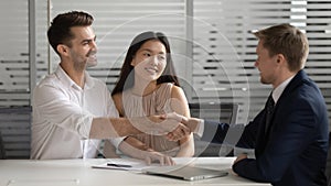 Male broker handshake happy couple congratulate with deal