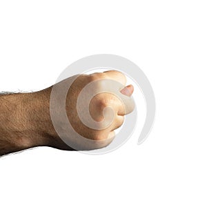 Male brutal hairy hand clenched into a fist and thumb sticks out between the middle and index fingers