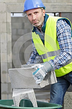 male builder carrying concrete wall