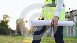 Male builder engineer man worker foreman architect in hard hat with drawing blueprint plan on construction site working