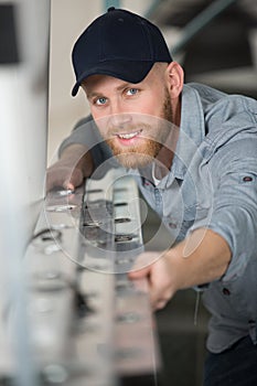 male builder with folded up ladder