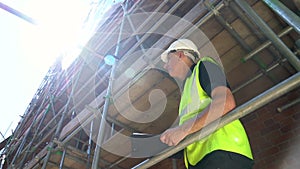 Male builder foreman, surveyor, worker or architect working on construction building site