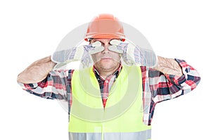 Male builder making the see no evil gesture