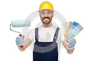 Male builder with paint roller and color palettes