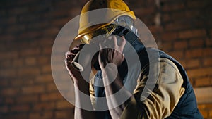 Male builder speaking on smartphone during lunch break