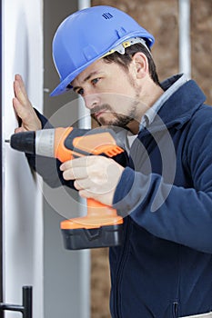 male builder using cordless drill