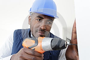male builder using drill