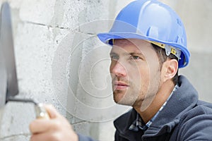 male builder working with cement block