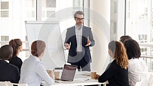 Male business coach speaker in suit give flipchart presentation