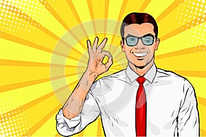 Male businessman in glasses winks and shows okay or OK gesture. Pop art retro vector illustration