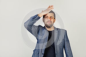 Male businessman resting his hand on his forehead remembering something important