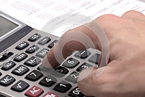 Male businessman using a calculator