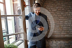 Businessperson with cell phone calling his fellow photo