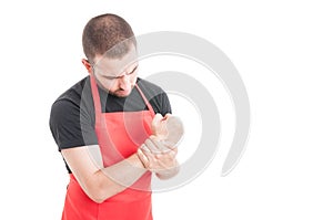 Male butcher having wrist pain