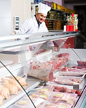 Male butcher in kosher section at supermarket