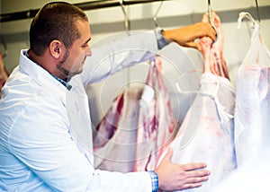 Male butcher in kosher section at supermarket