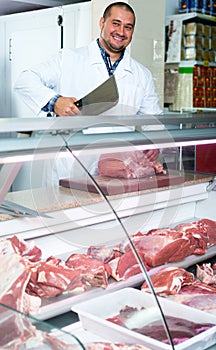 Male butcher in kosher section at supermarket