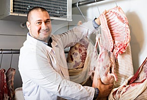 Male butcher in kosher section at supermarket