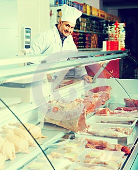 Male butcher in kosher section at supermarket