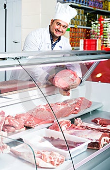 Male butcher in kosher section at supermarket