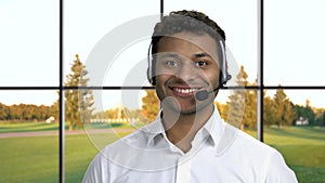 Male call center agent on windows background.