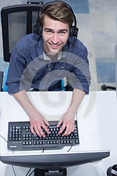 Male call centre operator doing his job top view
